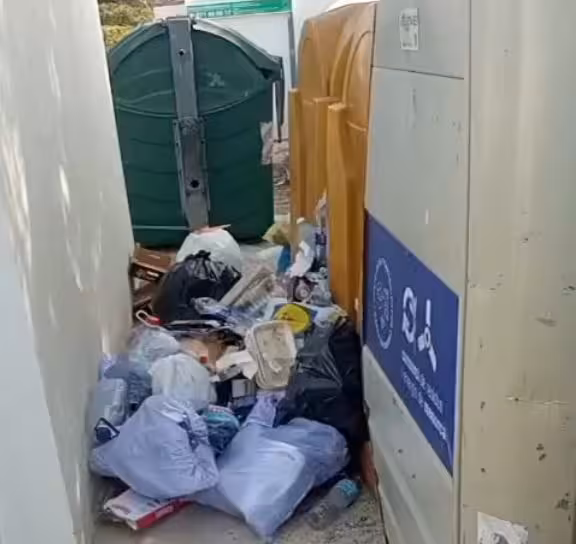 La suciedad y los escombros se acumulan junto a los contenedores de reciclaje en Cala Morell.
